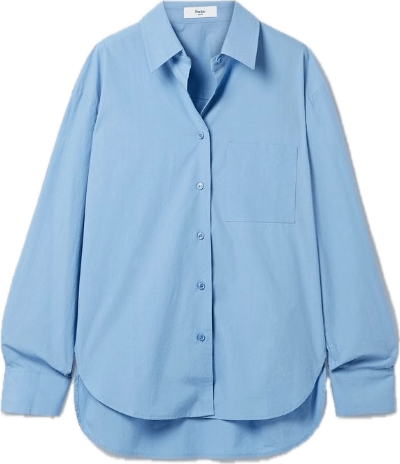 a light blue button-up, slightly oversized